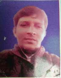 Portrait of Dr. Kapoor wearing traditional attire with academic books in background